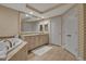 Elegant bathroom featuring a soaking tub, vanity, and chevron patterned wallpaper, creating a serene atmosphere at 3621 North Point Rd # 603, Osprey, FL 34229
