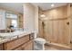 Bathroom featuring a walk-in shower with glass enclosure, granite counters and modern wallpaper at 3621 North Point Rd # 603, Osprey, FL 34229