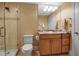 Bathroom features tiled walk-in shower, granite counters, and wood cabinetry at 3621 North Point Rd # 603, Osprey, FL 34229