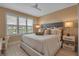 Comfortable bedroom featuring shutters, ceiling fan, and neutral colors at 3621 North Point Rd # 603, Osprey, FL 34229