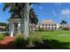 Stately clubhouse view features manicured lawns, tropical trees, and a charming gazebo at 3621 North Point Rd # 603, Osprey, FL 34229