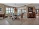 Bright dining area features a glass table, colorful chairs, and modern lighting fixture at 3621 North Point Rd # 603, Osprey, FL 34229