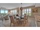 Open-concept dining area boasts natural light, a stylish chandelier, and a view into the living space at 3621 North Point Rd # 603, Osprey, FL 34229