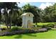 Elegant entrance to The Oaks Club featuring lush landscaping and decorative elements at 3621 North Point Rd # 603, Osprey, FL 34229