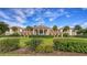 Stunning building featuring symmetrical design, a grand entrance, and lush greenery at 3621 North Point Rd # 603, Osprey, FL 34229