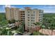 Well-maintained condo building with lush landscaping and mature trees at 3621 North Point Rd # 603, Osprey, FL 34229