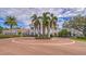 Picturesque building with a circular driveway, palm trees, and meticulously maintained landscaping at 3621 North Point Rd # 603, Osprey, FL 34229
