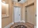 Hallway featuring tan walls, an elevator, and a white entry door at 3621 North Point Rd # 603, Osprey, FL 34229