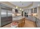 Bright kitchen featuring marble countertops, large island, stainless steel appliances, and custom cabinetry at 3621 North Point Rd # 603, Osprey, FL 34229