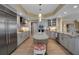 Bright kitchen featuring marble countertops, large island, stainless steel appliances, and custom cabinetry at 3621 North Point Rd # 603, Osprey, FL 34229
