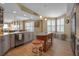 Bright open concept kitchen with marble countertops, island, stainless steel appliances, and open floor plan at 3621 North Point Rd # 603, Osprey, FL 34229