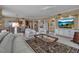 Inviting living room features built-in shelving, a large screen TV, and neutral decor at 3621 North Point Rd # 603, Osprey, FL 34229