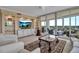 Cozy living room featuring neutral decor, large windows, and balcony access at 3621 North Point Rd # 603, Osprey, FL 34229