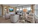 Bright living room with large TV, built in cabinets, and outdoor views at 3621 North Point Rd # 603, Osprey, FL 34229