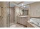 Bright bathroom featuring a shower, single sink and vanity, and detailed tiling at 3621 North Point Rd # 603, Osprey, FL 34229
