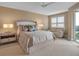 Comfortable main bedroom with a ceiling fan, access to a balcony, and a white leather love seat at 3621 North Point Rd # 603, Osprey, FL 34229