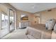 Bright main bedroom with balcony, mounted tv, and neutral finishes at 3621 North Point Rd # 603, Osprey, FL 34229