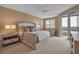 Spacious main bedroom featuring a king bed, seating area, and balcony access with scenic views at 3621 North Point Rd # 603, Osprey, FL 34229
