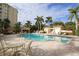Beautiful community swimming pool with lounge chairs and shaded seating areas at 3621 North Point Rd # 603, Osprey, FL 34229