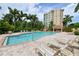 Inviting community pool with lounge chairs and manicured landscaping surrounding the building at 3621 North Point Rd # 603, Osprey, FL 34229