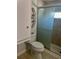 Bathroom featuring shower with sliding glass door, toilet, and built-in storage at 3710 Gulf Of Mexico Dr # E22, Longboat Key, FL 34228