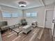 Bright bedroom featuring modern decor, light wood flooring, and natural light from the windows at 3710 Gulf Of Mexico Dr # E22, Longboat Key, FL 34228