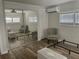 Bright bedroom featuring light wood flooring, neutral walls, and a large mirrored closet at 3710 Gulf Of Mexico Dr # E22, Longboat Key, FL 34228
