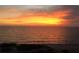 Breathtaking sunset view overlooking a serene ocean, with warm hues painting the sky and reflecting on the water at 3710 Gulf Of Mexico Dr # E22, Longboat Key, FL 34228
