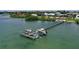Aerial view of a boat dock with multiple slips and boats on a serene waterfront property at 3921 Waypoint Ave, Osprey, FL 34229