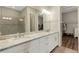Bathroom with double sinks, granite countertops and large mirror at 3921 Waypoint Ave, Osprey, FL 34229