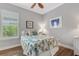 Bright bedroom featuring a tropical theme, wood-look floors, and plantation shutters at 3921 Waypoint Ave, Osprey, FL 34229