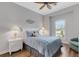 Comfortable bedroom with ceiling fan, wood floors, and natural light from the window at 3921 Waypoint Ave, Osprey, FL 34229