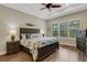 Nautical-themed bedroom with dark wood furniture and large window at 3921 Waypoint Ave, Osprey, FL 34229