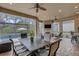 Entertain on this covered patio with fireplace, outdoor dining, and seating all overlooking the sparkling pool at 3921 Waypoint Ave, Osprey, FL 34229