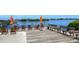 Relaxing dock with comfortable seating, orange umbrellas, and stunning waterfront views at 3921 Waypoint Ave, Osprey, FL 34229