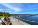 Inviting waterfront dock featuring wooden chairs, vibrant umbrellas, and picturesque water views at 3921 Waypoint Ave, Osprey, FL 34229