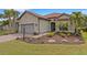 Charming single-story home boasts lush landscaping, paver driveway, and tile roof at 3921 Waypoint Ave, Osprey, FL 34229