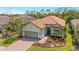 Aerial view of home showcasing manicured landscaping, neutral paint, brick driveway, and attached garage at 3921 Waypoint Ave, Osprey, FL 34229