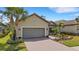Charming single Gathering home featuring a brick driveway, attached garage, and lush landscaping at 3921 Waypoint Ave, Osprey, FL 34229