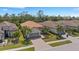 Aerial view of well-maintained home with a neutral color scheme, attached garage, and paved driveway at 3921 Waypoint Ave, Osprey, FL 34229