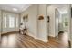 Inviting foyer boasts hardwood floors, elegant decor, and abundant natural light from the decorative glass front door at 3921 Waypoint Ave, Osprey, FL 34229