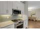 Modern kitchen featuring stainless steel appliances and adjacent dining area at 3921 Waypoint Ave, Osprey, FL 34229