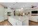 Bright and airy kitchen with white cabinets, granite countertops, and an island, flowing into the dining and living areas at 3921 Waypoint Ave, Osprey, FL 34229
