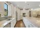 Well-lit kitchen featuring white cabinetry, modern appliances, and a spacious layout at 3921 Waypoint Ave, Osprey, FL 34229