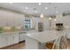 Modern kitchen featuring quartz countertops, stainless steel appliances, and bright white cabinetry at 3921 Waypoint Ave, Osprey, FL 34229