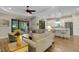 Spacious living area with a comfortable sofa, wood floors, and sliding doors leading to the outdoor living space at 3921 Waypoint Ave, Osprey, FL 34229