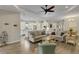 Open-concept living space featuring a kitchen, dining area, and living room with hardwood floors and neutral decor at 3921 Waypoint Ave, Osprey, FL 34229