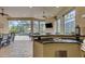 Inviting outdoor kitchen with granite countertops, stainless steel grill and open view of the pool and backyard at 3921 Waypoint Ave, Osprey, FL 34229