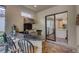 Outdoor kitchen with stone bar, stainless steel grill, and pass-through window to the indoor kitchen at 3921 Waypoint Ave, Osprey, FL 34229