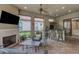 Covered outdoor space with a fireplace, seating area, grill, and bar, all overlooking the pool at 3921 Waypoint Ave, Osprey, FL 34229